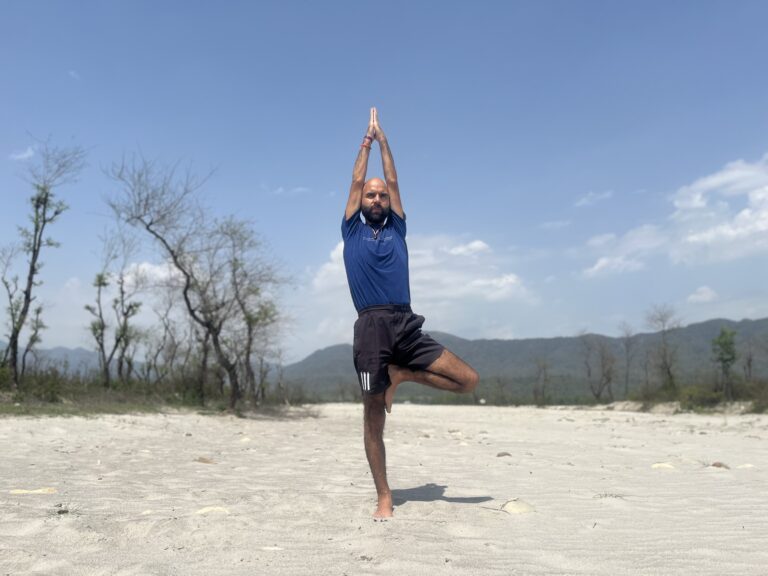 In this picture one person is standing on his one leg while the other leg is folded and on the thigh .Both hands are upright straight and making namaskar mudra .